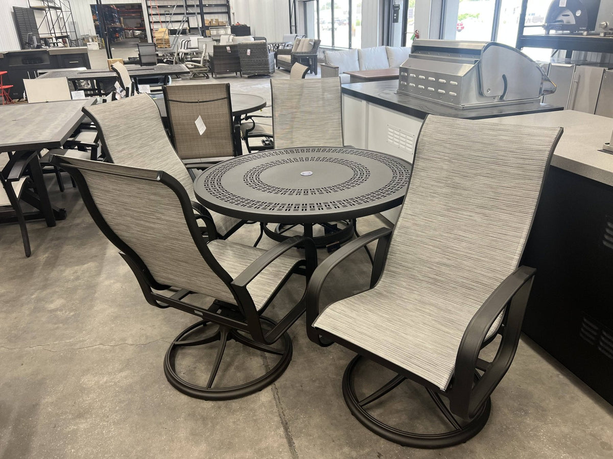 Local Special: Woodard 48" Trellis Top Dining Table in Twilight Finish with 4 Woodard Cayman Isle Sling Rocker Dining Chairs in Twilight Finish with Watercolor Tweed Sling